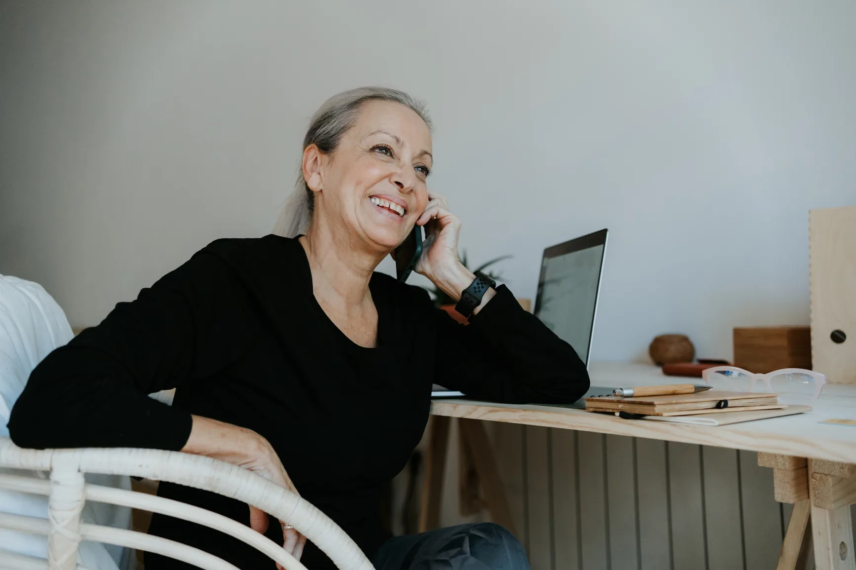 A calm moment with a phone and notes used to track appointments and next steps