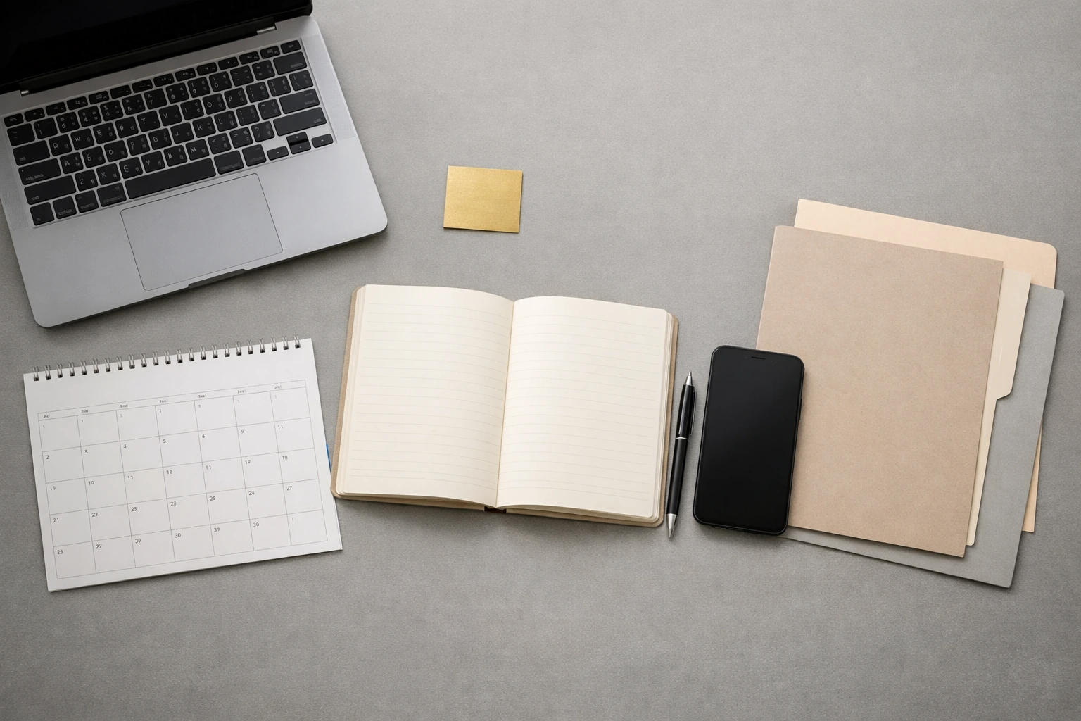 A person working with a laptop and notes